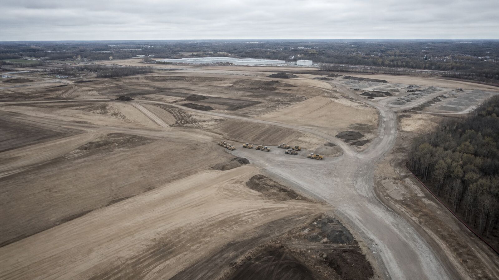 Aerial of graded lots and earthwork on a Detroit Metro land-development site.